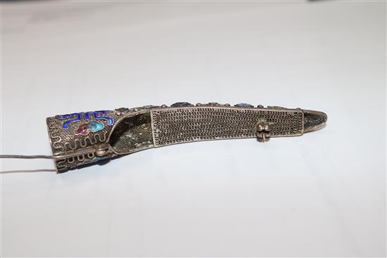 A late 19th/early 20th century Chinese silver filligree, enamel and gem set nail guard, 86mm.